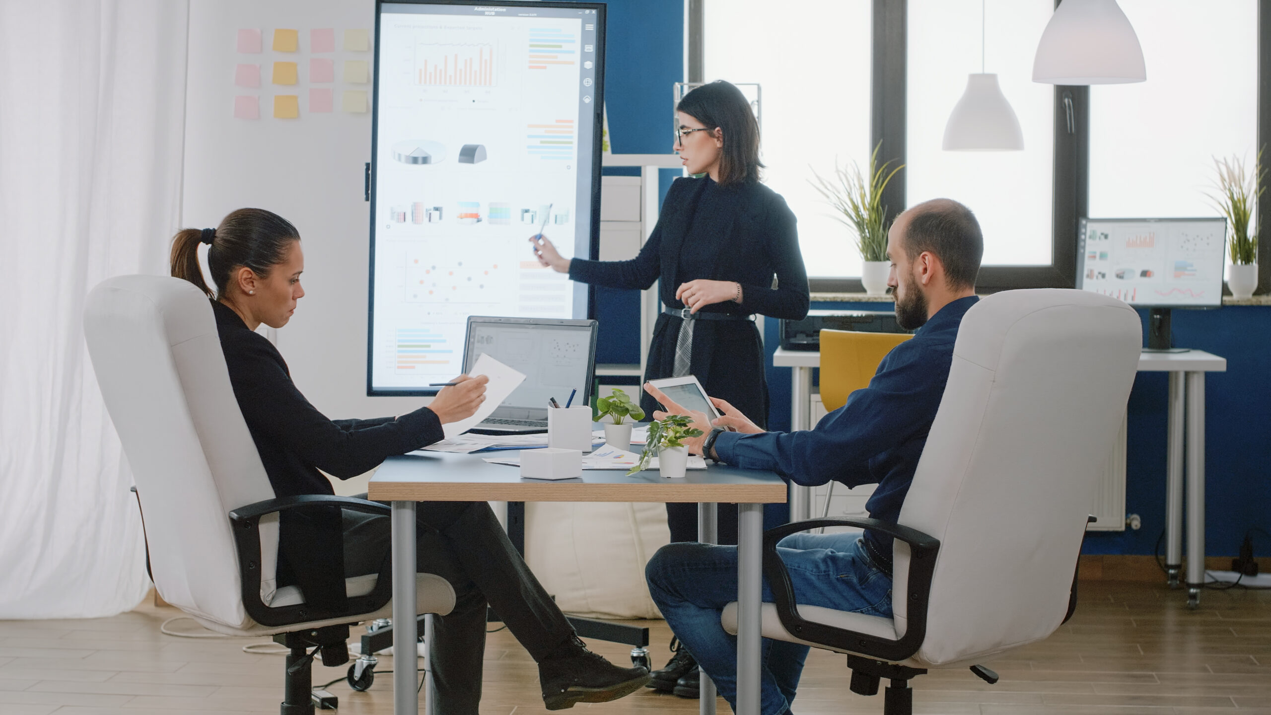 Colleagues attending business meeting in boardroom